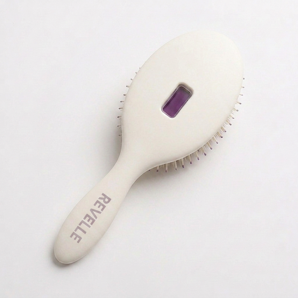 The Revelle brush in Chalk, angled to show the embossed wordmark and purple viewing window